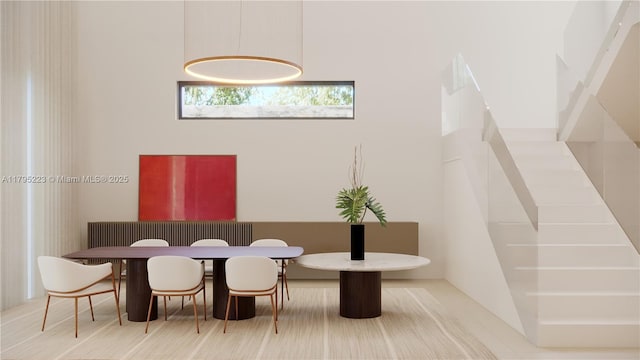 dining space featuring a towering ceiling
