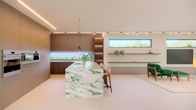 interior space featuring a center island, light countertops, modern cabinets, and light tile patterned floors