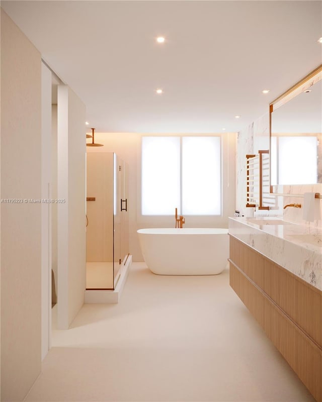 full bath with double vanity, a soaking tub, a shower stall, and recessed lighting