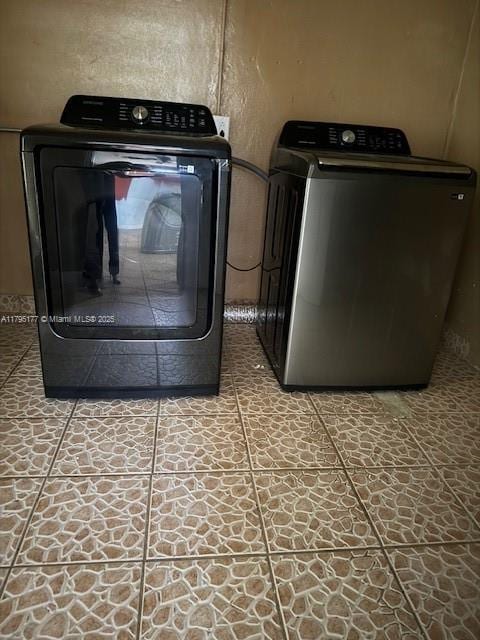 clothes washing area with laundry area and washer and dryer