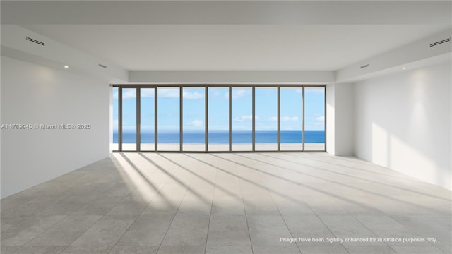 tiled spare room featuring visible vents and a water view