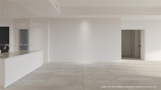 spare room with recessed lighting and a sink
