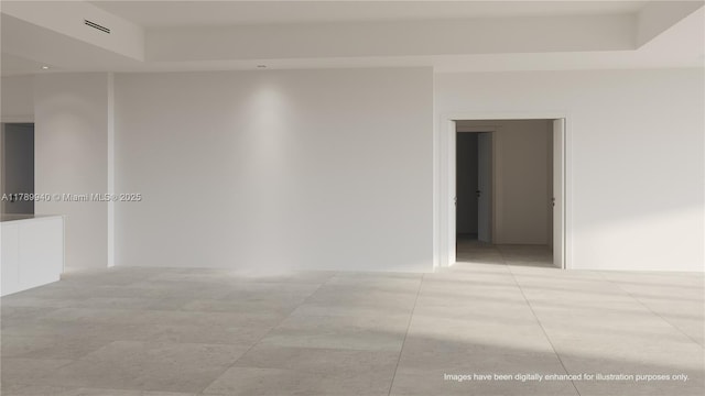 empty room with visible vents and a raised ceiling