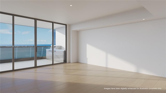 unfurnished room with expansive windows