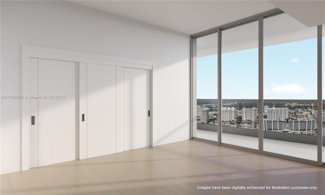 interior space with floor to ceiling windows and multiple closets