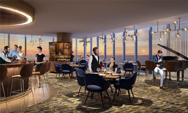 carpeted dining space with a water view and a community bar
