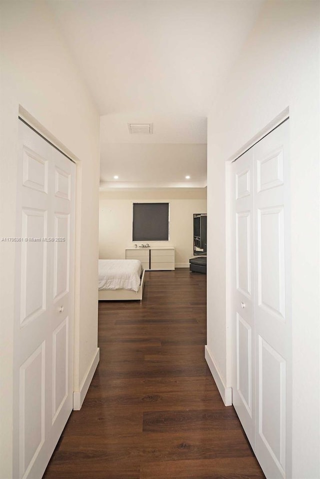 hallway with baseboards, recessed lighting, visible vents, and dark wood-style floors