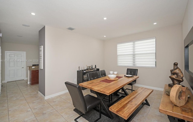 dining room with light tile patterned flooring and recessed lighting