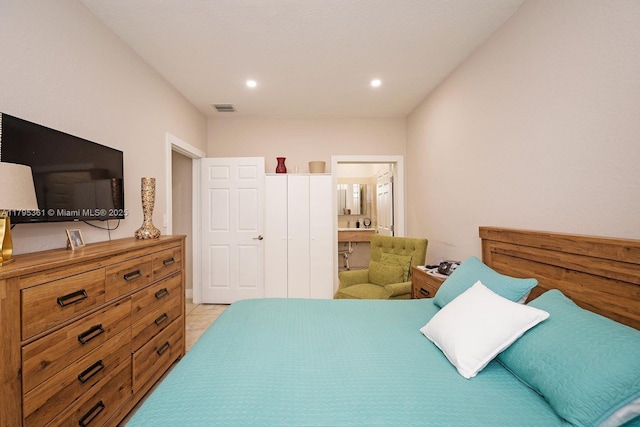 bedroom featuring light tile patterned floors, recessed lighting, ensuite bath, and visible vents