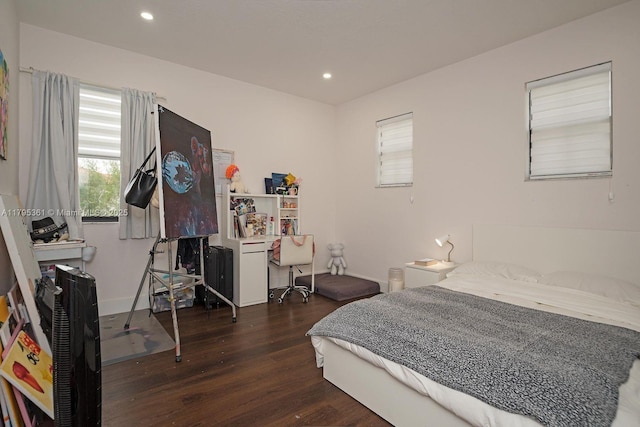 bedroom with wood finished floors and recessed lighting