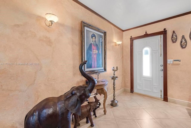 foyer entrance featuring crown molding, baseboards, and light tile patterned floors