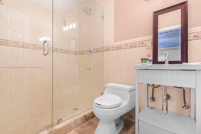 bathroom with toilet, tile walls, and a stall shower