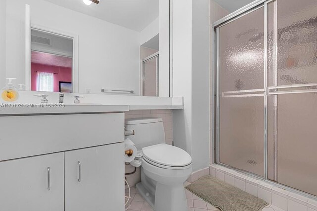 8241 SW 146th St, Palmetto Bay, FL 33158 - bathroom with vanity, toilet, tile patterned floors, and a stall shower