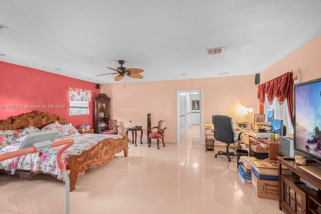bedroom with light tile patterned floors, a ceiling fan, and visible vents