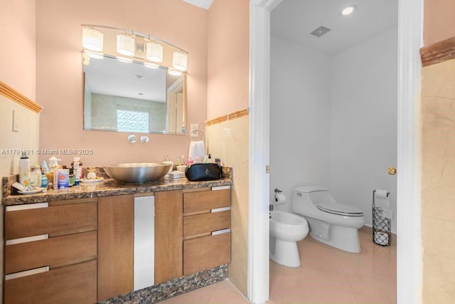 full bath with visible vents, tile patterned flooring, vanity, toilet, and a bidet
