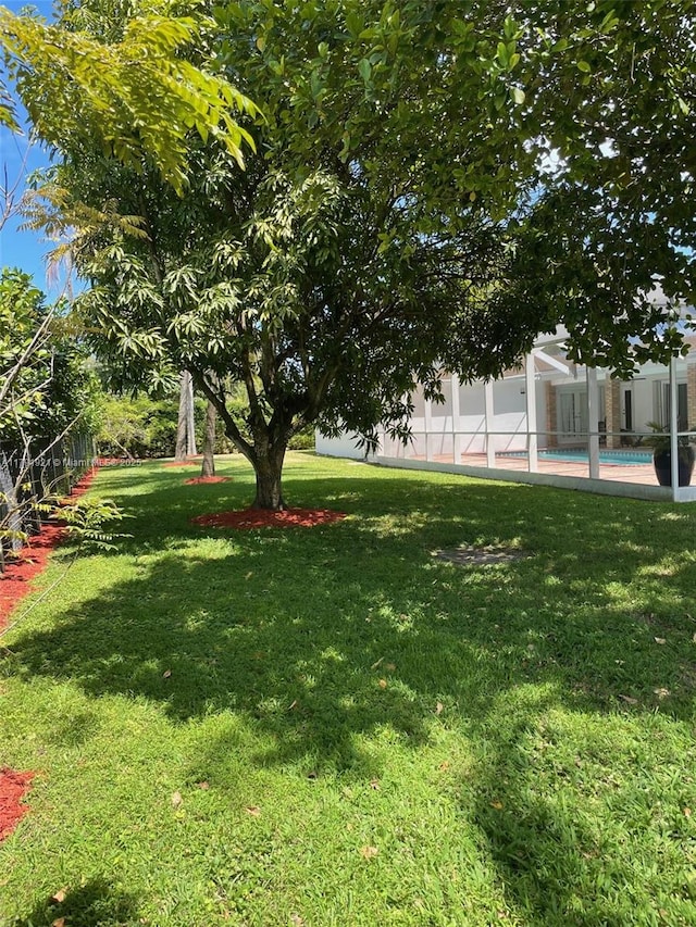 view of yard featuring a fenced in pool and fence