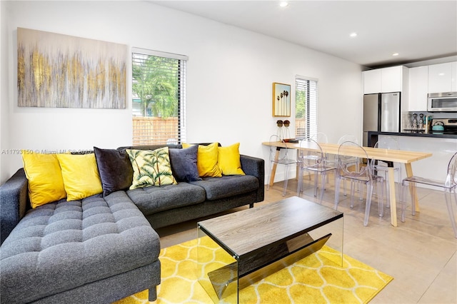 living area with light tile patterned flooring, recessed lighting, and plenty of natural light