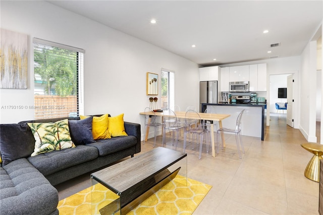 living area with recessed lighting and visible vents
