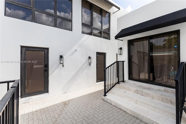 entrance to property with stucco siding