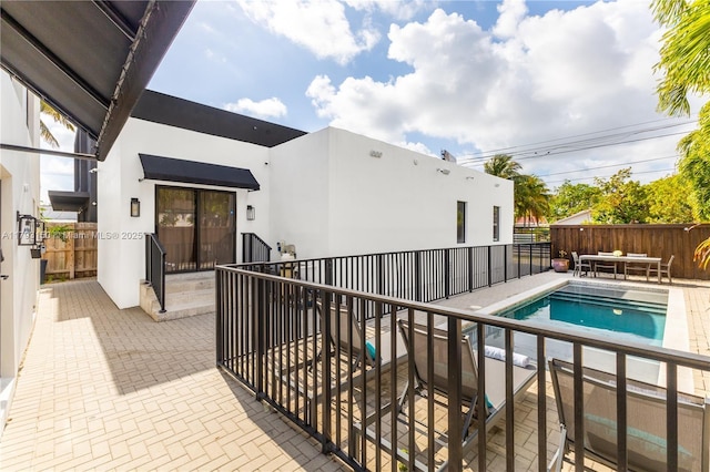 view of swimming pool featuring a patio area, a fenced in pool, and fence