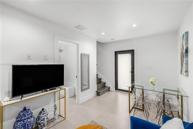 living area with visible vents, recessed lighting, stairway, light tile patterned floors, and baseboards