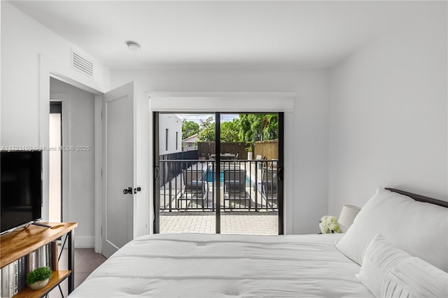 bedroom featuring baseboards, visible vents, and access to exterior