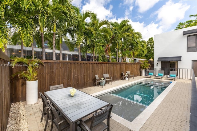 view of swimming pool with fence, a fenced in pool, and a patio area