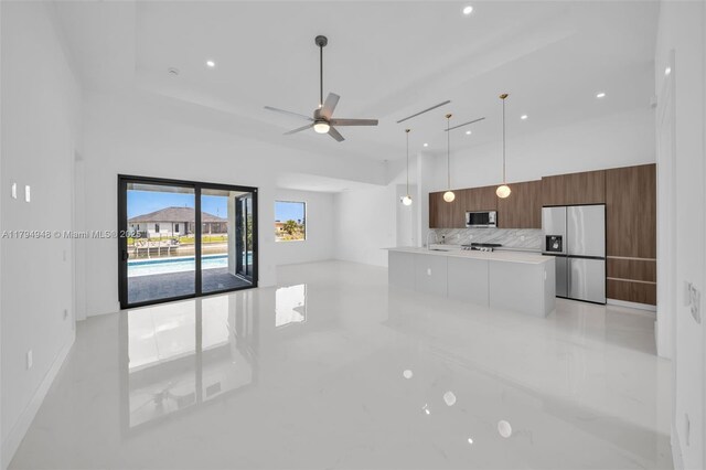 1427 NW 17th St, Cape Coral, FL 33993 - unfurnished living room with a high ceiling, a ceiling fan, and recessed lighting