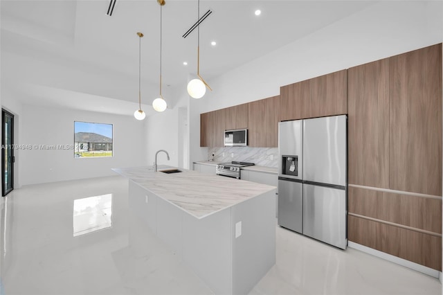 1427 NW 17th St, Cape Coral, FL 33993 - kitchen with appliances with stainless steel finishes, a sink, brown cabinetry, tasteful backsplash, and modern cabinets