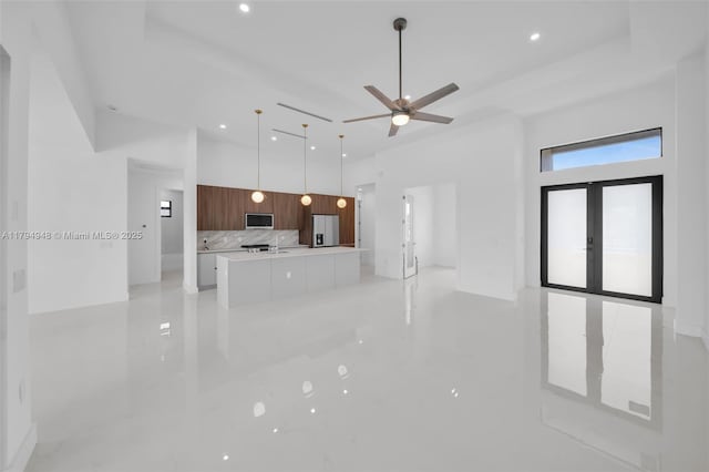 1427 NW 17th St, Cape Coral, FL 33993 - unfurnished living room featuring french doors, recessed lighting, a towering ceiling, and ceiling fan