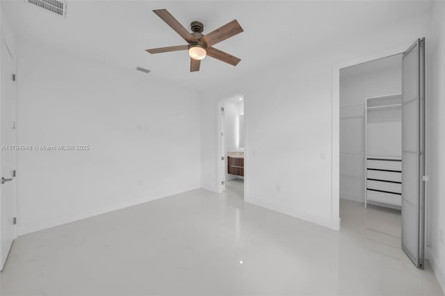 1427 NW 17th St, Cape Coral, FL 33993 - unfurnished bedroom with a walk in closet, visible vents, finished concrete flooring, a closet, and ensuite bath