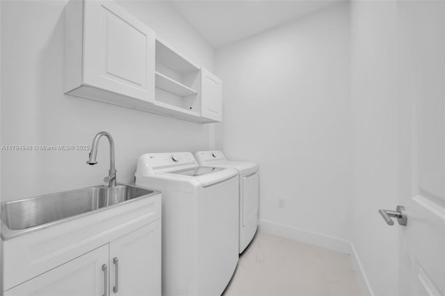 1427 NW 17th St, Cape Coral, FL 33993 - laundry area with a sink, baseboards, cabinet space, and washer and dryer