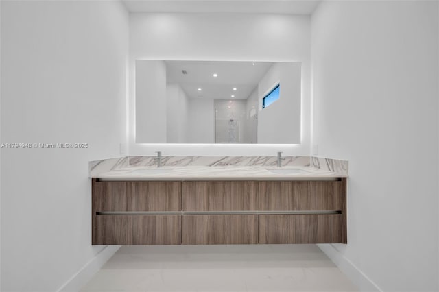 1427 NW 17th St, Cape Coral, FL 33993 - full bathroom with double vanity, baseboards, marble finish floor, and a stall shower