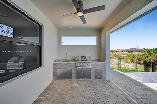 1427 NW 17th St, Cape Coral, FL 33993 - view of patio featuring fence, ceiling fan, grilling area, and an outdoor kitchen
