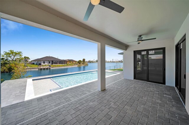 1427 NW 17th St, Cape Coral, FL 33993 - outdoor pool featuring a ceiling fan, a water view, and a patio area
