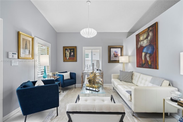 living area featuring light tile patterned floors and baseboards