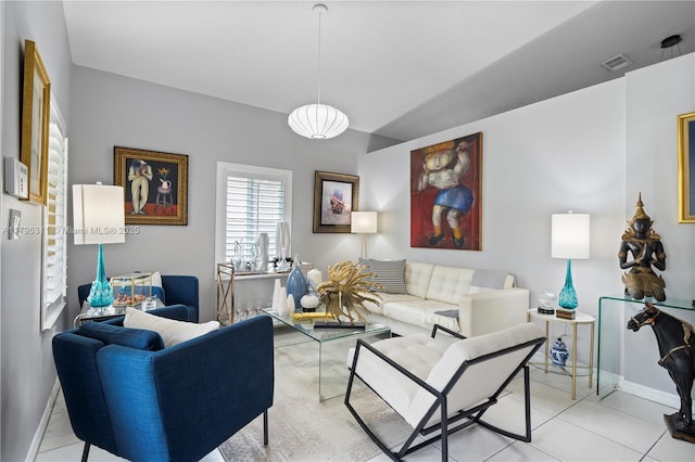 tiled living area with baseboards and visible vents