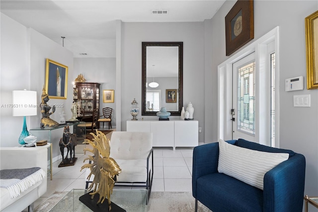 living area with light tile patterned flooring and visible vents