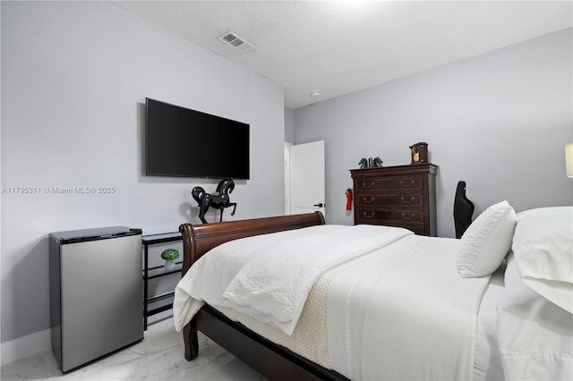 bedroom with marble finish floor, freestanding refrigerator, baseboards, and visible vents
