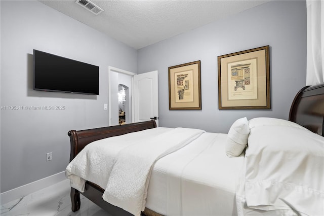 bedroom featuring marble finish floor, a textured ceiling, baseboards, and visible vents