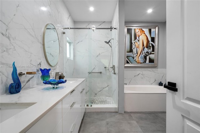 bathroom with a sink, a marble finish shower, tile patterned flooring, double vanity, and a bath