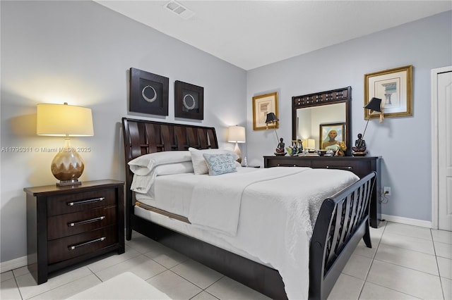 bedroom with baseboards, light tile patterned floors, and visible vents
