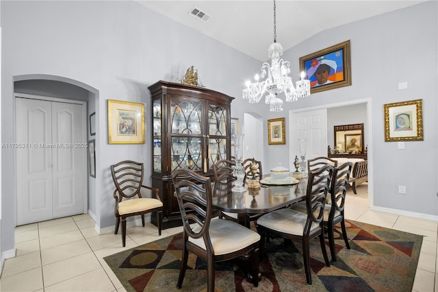 dining room featuring light tile patterned flooring, high vaulted ceiling, visible vents, arched walkways, and a notable chandelier