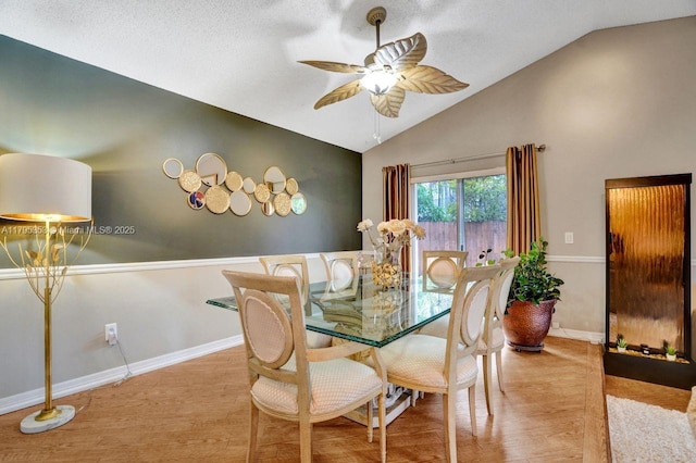 dining room featuring wood finished floors, baseboards, ceiling fan, high vaulted ceiling, and a textured ceiling