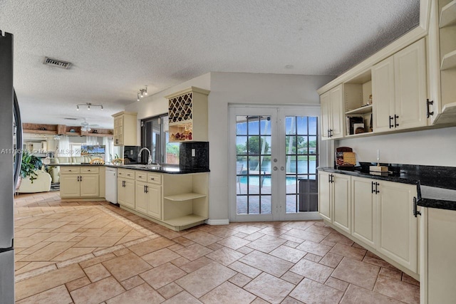 kitchen with open shelves, dishwasher, french doors, a peninsula, and visible vents