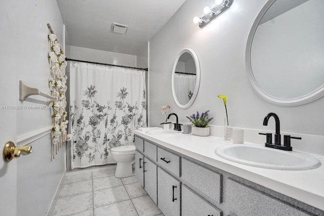 bathroom featuring a sink, a shower with curtain, toilet, and double vanity