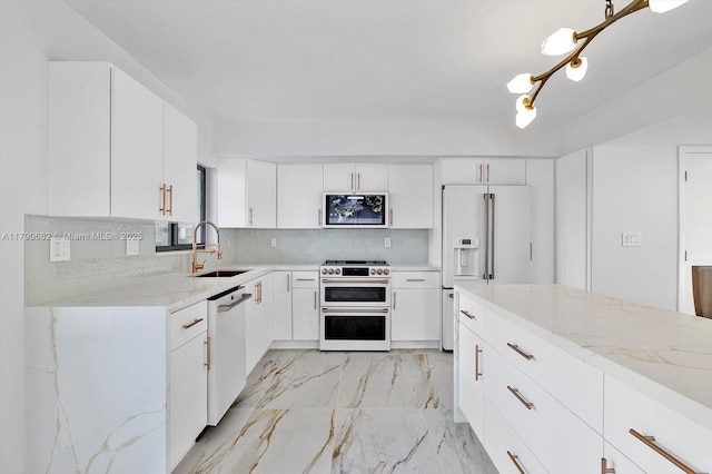 kitchen featuring a sink, decorative backsplash, light stone countertops, and high quality appliances