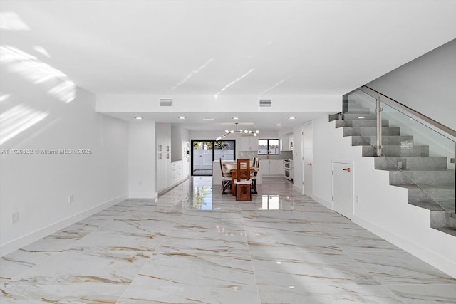 living area featuring baseboards, marble finish floor, stairs, and visible vents