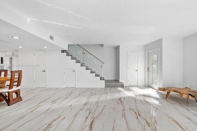 unfurnished living room with recessed lighting, visible vents, stairs, and marble finish floor