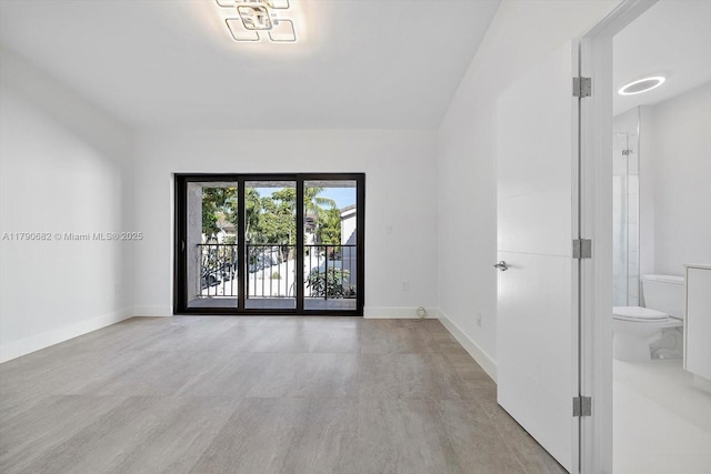 unfurnished room featuring baseboards